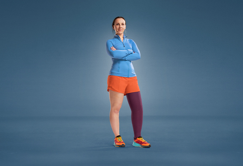 JOBST ambassador Angharad is standing on a blue background, dressed in athletic wear, with a purple compression garment on her leg. JOBST ambassador Angharad is standing on a blue background, dressed in athletic wear, with a purple compression garment on her leg.